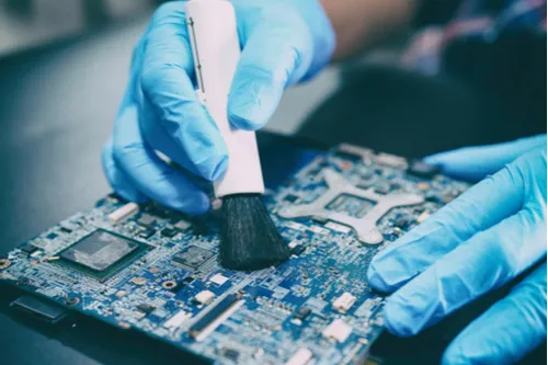Hands Cleaning a SoC board